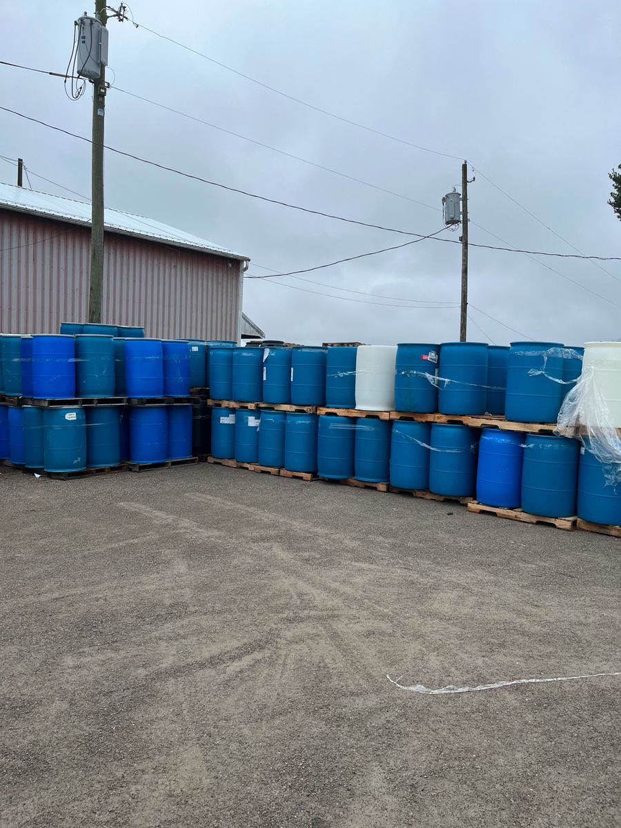 A pile of barrels in a driveway
